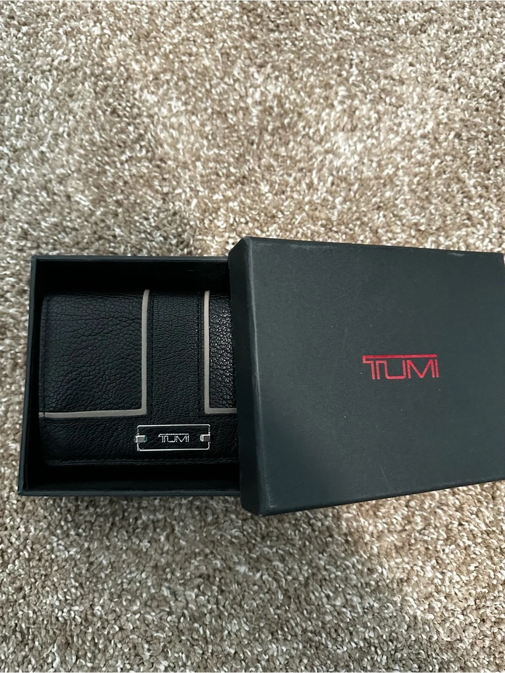 Tumi Black Leather Wallet with Light Trim and Metal Logo
